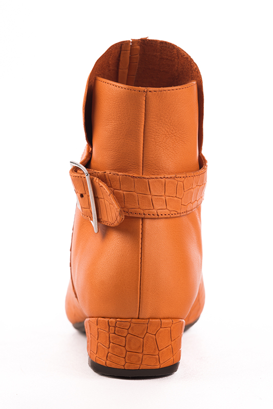 Apricot orange women's ankle boots with buckles at the back. Round toe. Low block heels. Worn view - Florence KOOIJMAN